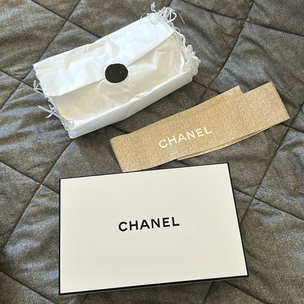 Chanel box with tissue paper and filling material and sparkly ribbon